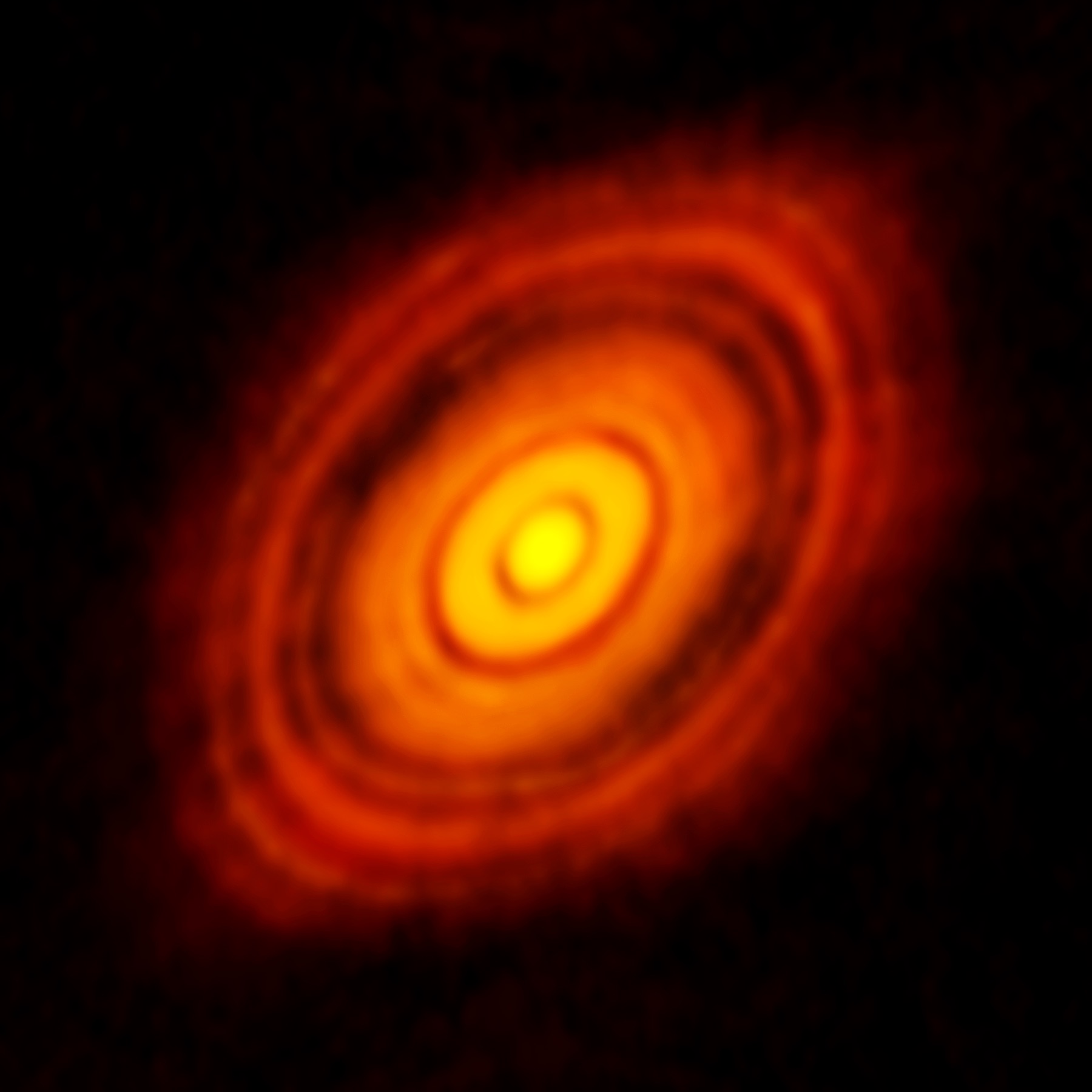 This is the sharpest image ever taken by ALMA — sharper than is routinely achieved in visible light with the NASA/ESA Hubble Space Telescope. It shows the protoplanetary disc surrounding the young star HL Tauri. These new ALMA observations reveal substructures within the disc that have never been seen before and even show the possible positions of planets forming in the dark patches within the system.